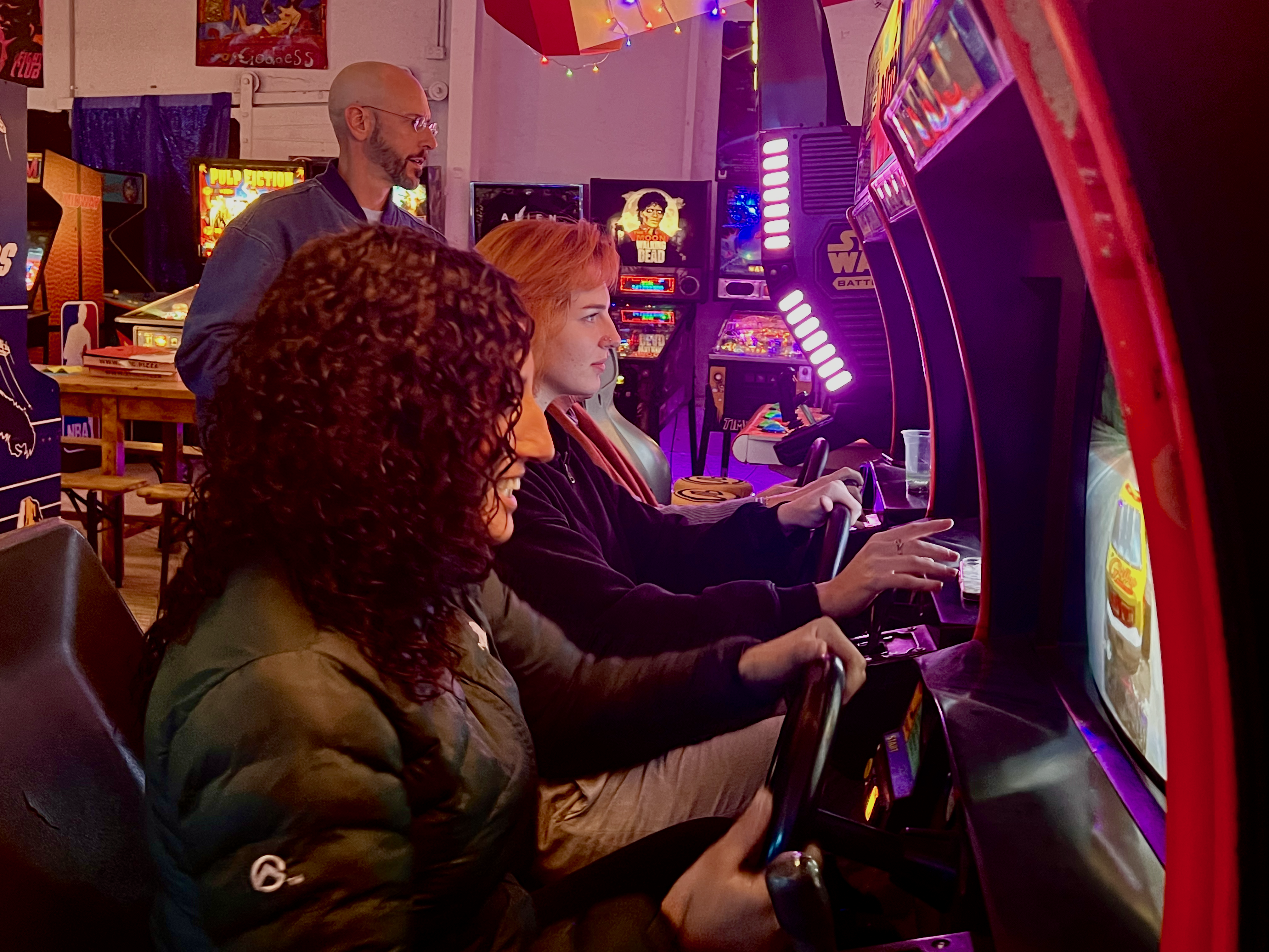 Trivia team on a driving arcade machine at Wondercade